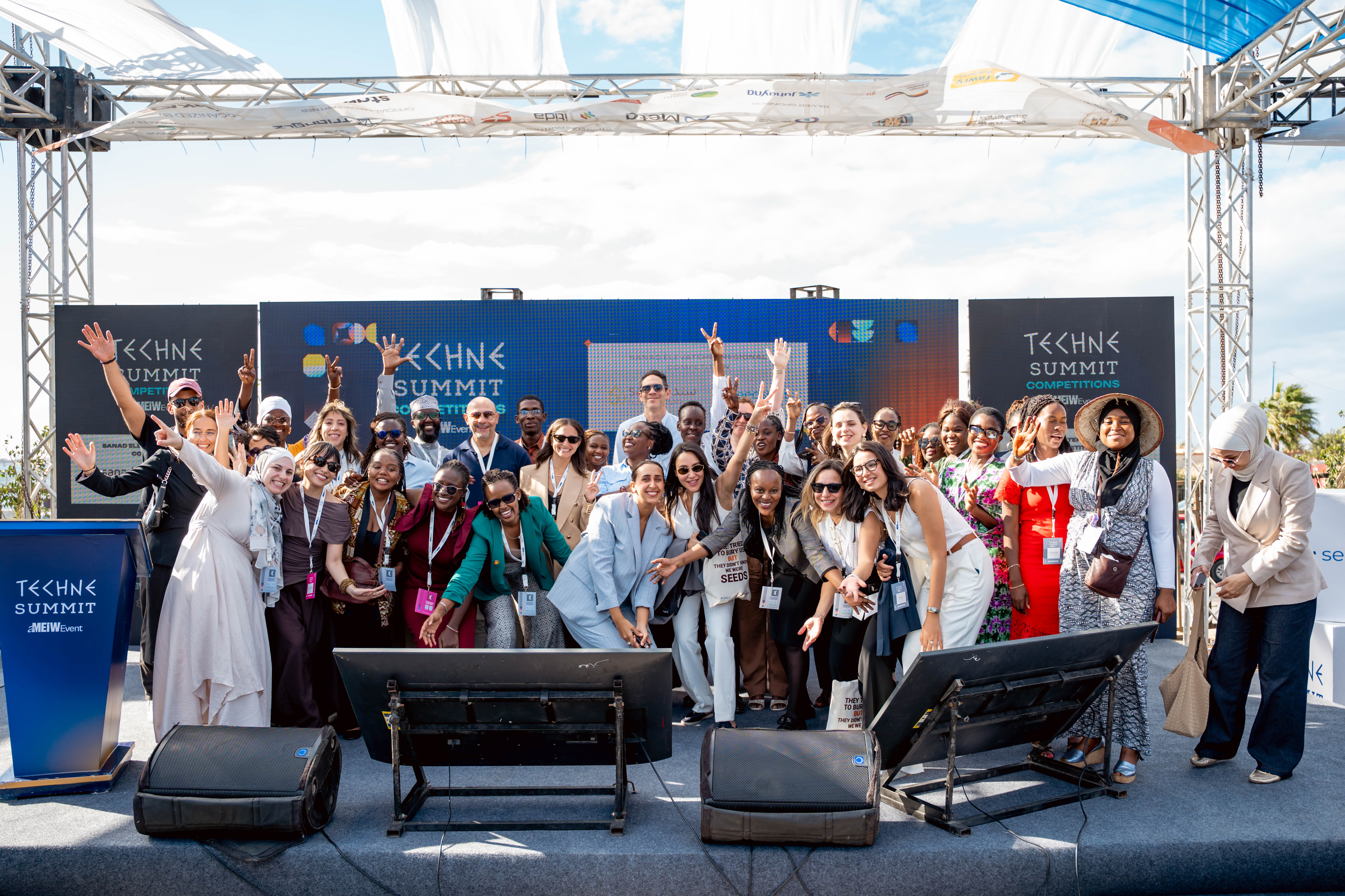 A group photograph on the competition stage during the SANAD ElevateHer pitch-day activities in Alexandria on 3 October 2026.